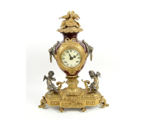 20th century German cast metal and gilt metal mounted by Imperial, of urn form , two train movement, enamel dial, on stepped 