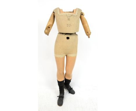 Fery Boudrot girl mannequin, c1910, the body covered with linen, articulated at the waist and arm joints, the feet with black