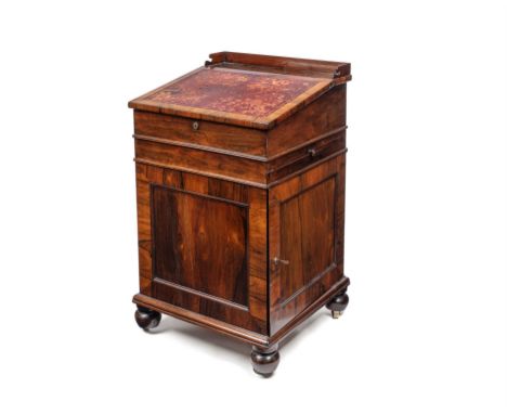 Early Victorian rosewood davenport by Williams & Gibton, the slope top enclosing two drawers and two dummy drawers with sprin
