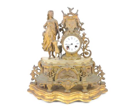 Victorian spelter clock, the case with young woman and goat by coat of arms, the enamel dial with Roman and Arabic numerals, 