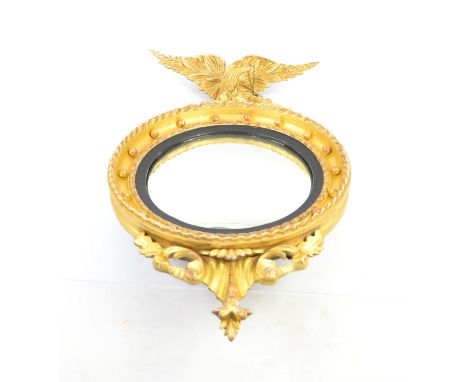 Early 19th century giltwood and gesso convex mirror with eagle finial 78cm x 42