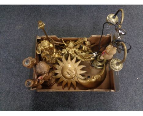 A box containing brass two way light fitting, chalk sun and moon ornaments, cherub table lamp etc.   