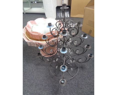 A wrought iron table standing candelabra with glass drops, together with a quantity of table lamp and light shades.  