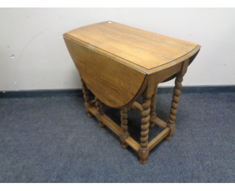 An oak barley twist gate leg table.  