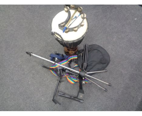 A drum, four various guitar/instrument stands, a soft carry case for a mandolin, guitar straps, recorder and a tambourine. (Q