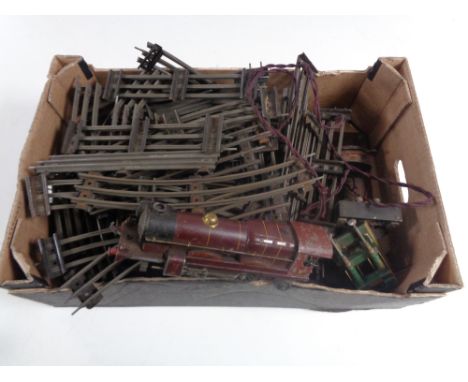 A box containing mid 20th century tin plate track and Royal Scot engine. 