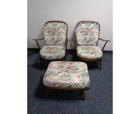 A pair of Ercol elm and beech armchairs with matching footstool together with one further Ercol armchair 