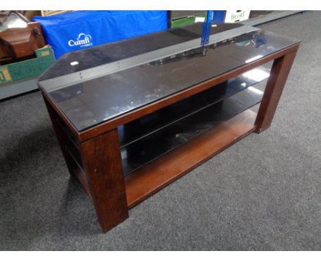 A contemporary wood and black glass three tier TV stand.  