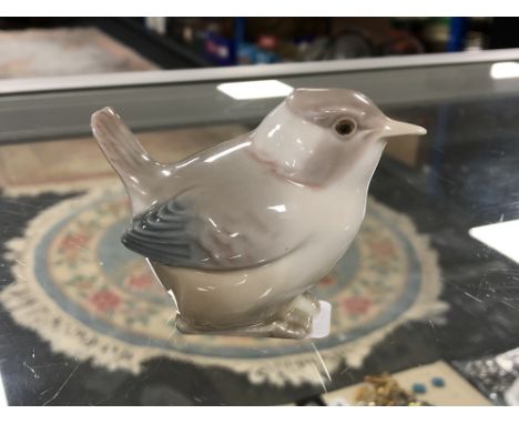 A Lladro figure of a bird. 