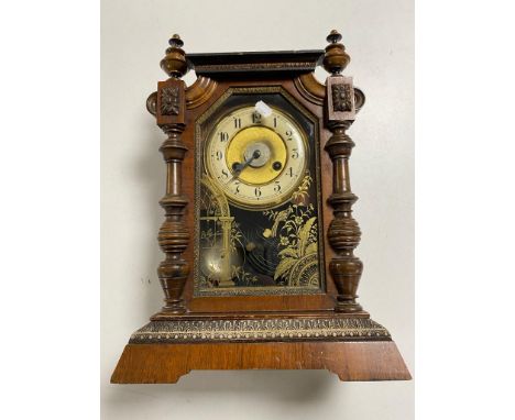 An antique pine cased Junghans bracket clock with brass and enamelled dial, pendulum and key 