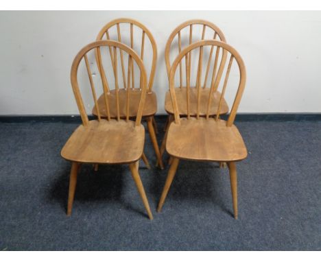 A set of four Ercol elm spindle back chairs 