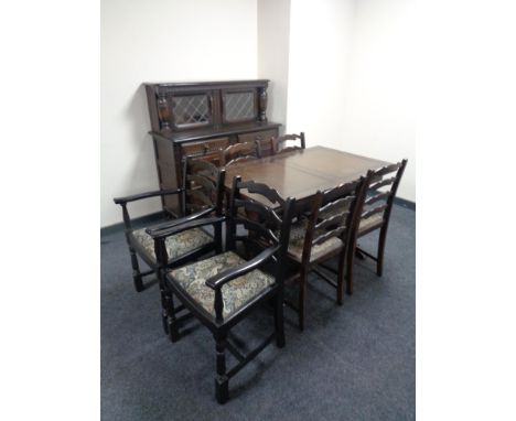 An eight piece dining room suite comprising of buffet back sideboard, refectory extending table and six ladder back chairs