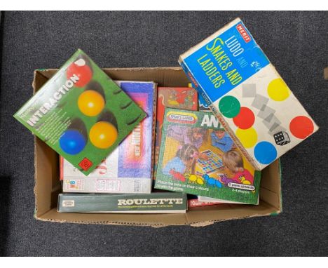A box containing vintage board games by Merit, Waddingtons etc.  