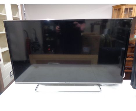 A Panasonic TX-40CS260B LCD TV on stand with lead and remote.  
