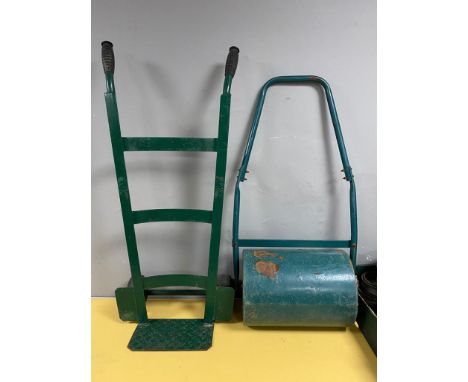 A garden roller together with a sack barrow.  