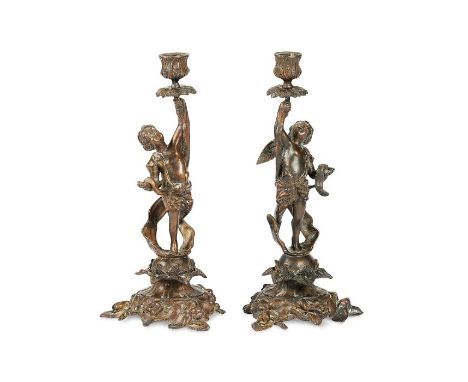 A pair of late 19th century French bronze candlesticks by F. Souchal, ParisIn the Louis XV style, the stems as putti holding 