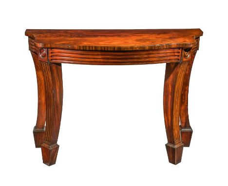 A George IV mahogany console or serving tableThe flame figured top above a reeded frieze on downswept reeded legs headed by r