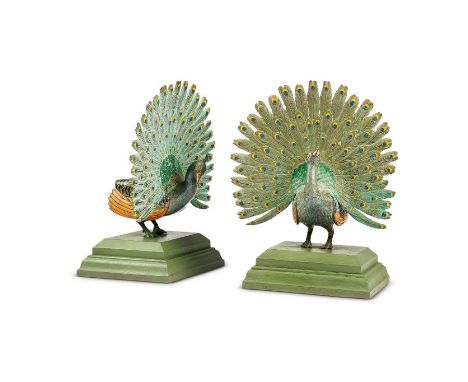 A pair of mid 20th century cold painted bronze peacock book endsOn rectangular plinth bases, each 32cm high. (2)