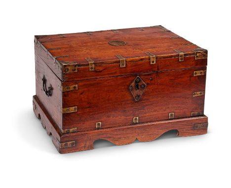 A 19th century Chinese teak and brass bound boxThe hinged lid enclosing six compartments; above a shaped apron on bracket fee