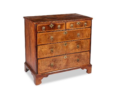 A Queen Anne walnut and featherbanded chestThe rectangular top of later date above two short and three long graduated drawers
