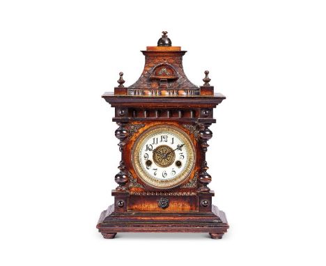 A late 19th century German stained beech carved mantel clock Applied with gilt metal mounts, the pagoda top and finials above