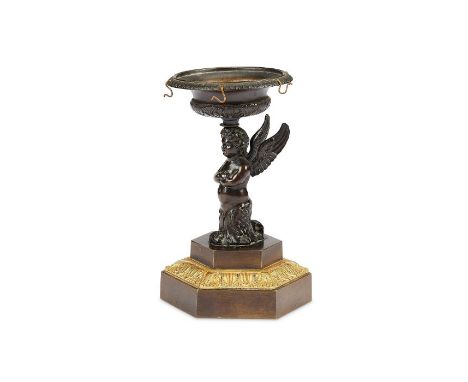 A Regency patinated bronze ring standThe circular urn shaped tray above a winged putti, on an octagonal base, 13cm high.