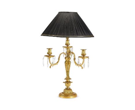 A 19th century French Louis XVI style gilt bronze candelabra
The leaf cast sconces with scrolling arms and cut glass pendant 