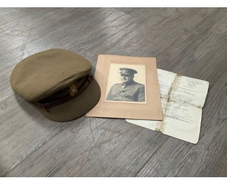A WWII RAOC officer's hat, previously belonging to MAJOR T.W.R. BRIDSON RAOC, with portrait photograph and discharge document