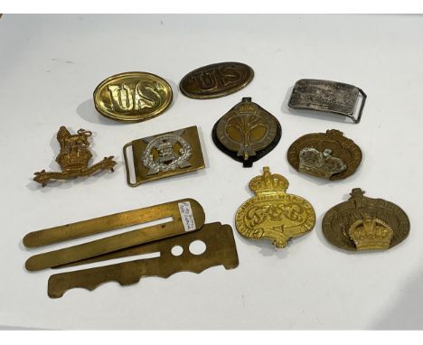 A quantity of military insignia including valice badges, US buckles, button polishers etc 