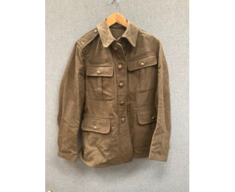 A WWI British army jacket with Suffolk shoulder titles, some moth damage, with label S.D. Jackets, dated 1915 