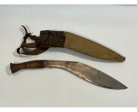 A WWII kukri together with canvas and brown leather sheath with one of two knives. Provenance: Belived to have been standard 
