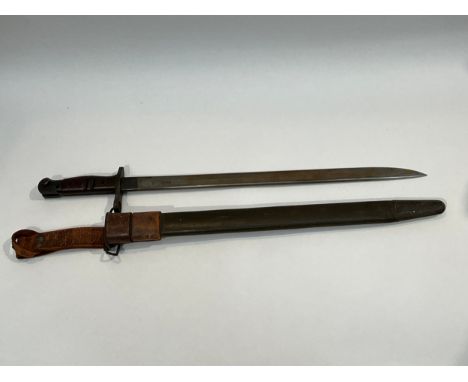 A WWI 1917 Remington bayonet with steel mounted leather scabbard and brown leather belt frog 