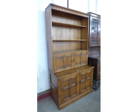 An Ercol Golden Dawn elm bookcase 