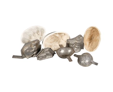 Antique pressed metal chocolate moulds, tallest being a hare beating a drum, 11cm, and 3 decorative ceramic jelly moulds