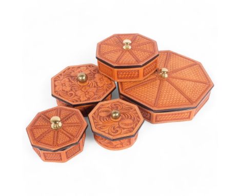 A group of 5 tan tooled leather boxes and covers, of octagonal and circular form, widest 30cm, all from the workshop of saddl