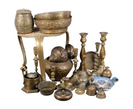 A large brass tripod trivet, candlesticks, chamber stick, etc
