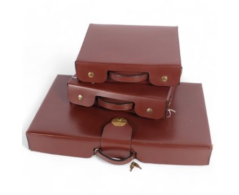 A brown leather briefcase with sectional interior, with shoulder strap, together with a pair of small brown leather briefcase