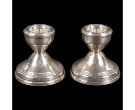 A pair of dwarf silver candlesticks with weighted bases