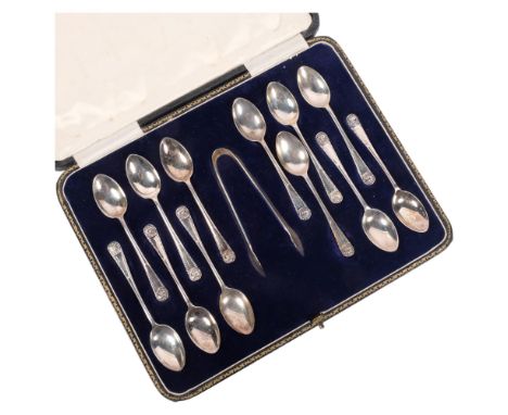 A cased set of 12 George V silver teaspoons and matching tongs, with lion mask decoration