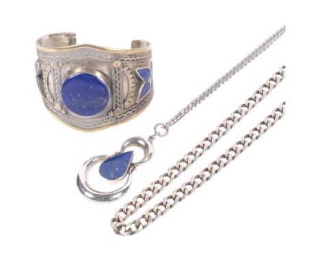 An Afghani silver on brass lapis lazuli set cuff bangle, a silver curb link necklace, and a silver and lapis lazuli set penda
