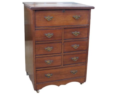 A Vintage mahogany floor standing sewing cabinet, with 6 short and 1 long drawer, with false drawer at top, hinged lid to rev