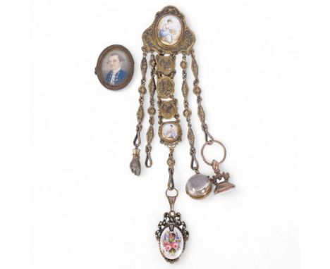 An Antique ornate brass chatelaine, with various accoutrements, including gilt-metal and agate seal, glass magnifying ball, a