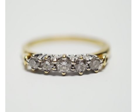 A modern 18ct gold and graduated five stone diamond set half hoop ring, size T, gross weight 4.4 grams.