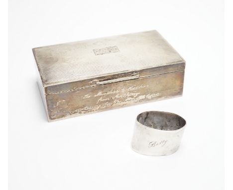 A modern part engine turned silver cigarette box, with engraved inscription, 16cm and a silver serviette ring.