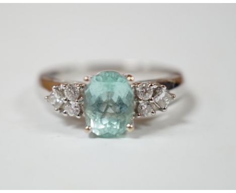 A modern 18ct gold and oval cut paraiba tourmaline set dress ring with six stone diamond set shoulders, size O, gross weight 