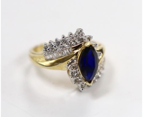 A modern 14kt, sapphire and diamond set crossover cluster ring, size M, gross weight 5.5 grams.