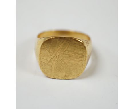 A 750 yellow metal signet ring, size N, 8.9 grams.