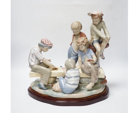 A large Nao figure group on stand of five boys sitting around a table playing cards, 33cm