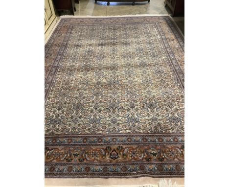 A North West Persian ivory ground carpet, 354 x 247cm