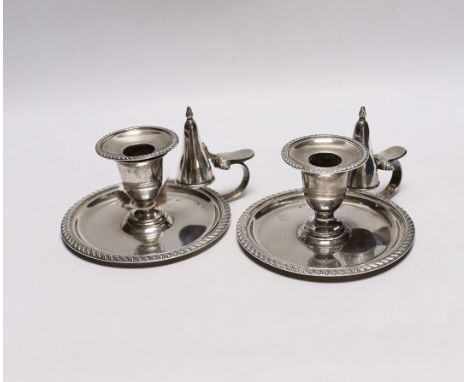 A pair of late Victorian silver chambersticks, with gadrooned borders and matching extinguishers, William Hutton &amp; Sons, 